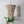 Handmade wooden bead chandelier with tropical plant and carved wall art in a modern room