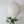 Off white round linen lantern chandelier hanging above a green plant, handcrafted in Bali.