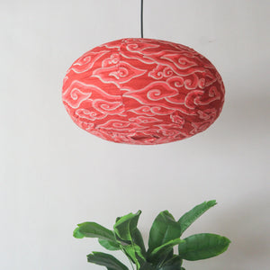 Fabric chandelier batik in oval shape, red linen hanging lamp, authentic Bali design, customizable and free international shipping.