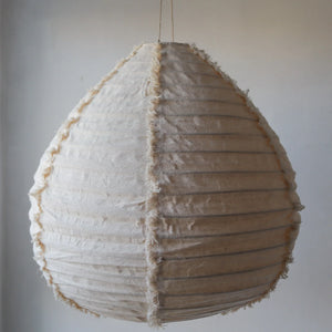 Handmade natural fabric pendant lamp with vertical textured seams, minimalist home decor