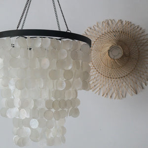 Capiz shell chandelier in black and white hanging decor, handcrafted in Bali, Indonesia, with unique shell design.