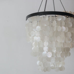 Capiz shell chandelier in black and white, handmade in Bali, Indonesia, featuring elegant circular shells.