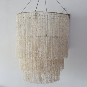 Large tiered seashell chandelier, handmade in Bali, perfect for coastal decor.