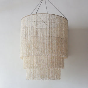 Handmade tiered seashell chandelier from Bali, Indonesia, featuring natural shells and customizable design options.