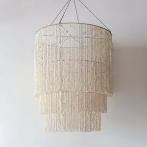 Handmade large seashell chandelier in tiered design, crafted in Bali, offering customizable colors and free shipping worldwide.