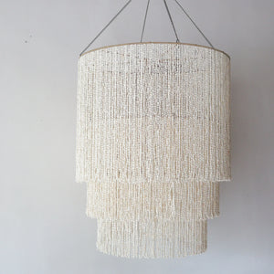 Large tiered seashell chandelier, handmade in Bali, perfect coastal decor for any space.