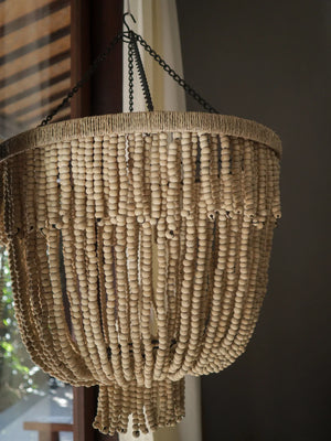Handmade wooden bead chandelier with natural finish hanging indoors