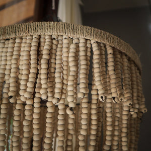Close-up of boho beaded chandelier with natural wooden beads and woven top.