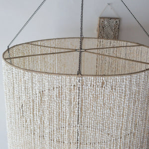 Large seashell chandelier, handmade in Bali, featuring tiered design and customizable options.