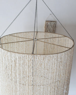 Handmade large seashell chandelier, tiered design, crafted in Bali, Indonesia, perfect for coastal decor.