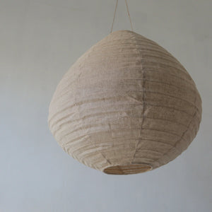 Handmade natural fiber pendant light with a textured, teardrop-shaped lampshade