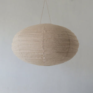 Handmade natural fiber pendant light with textured beige fabric, minimalist home decor