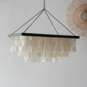 Rectangular seashell chandelier with layered capiz shells hanging from black frame