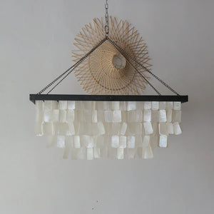 Handmade seashell chandelier with layered white capiz shells and rattan wall decor