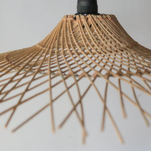 Handwoven rattan pendant light with natural finish, showcasing intricate craftsmanship