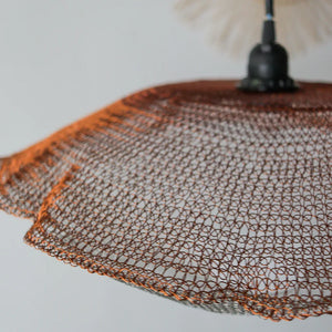 Handcrafted copper wire lampshade with a woven mesh design for modern home decor