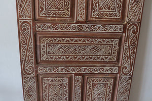 Hand-carved Balinese wooden door with intricate geometric patterns