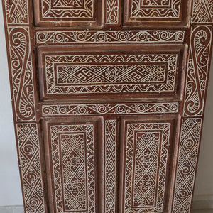 Hand-carved wooden door with intricate Balinese patterns and swirling motifs