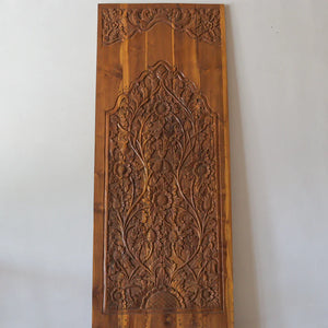 Hand-carved Balinese wooden door panel with intricate floral patterns