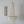 Handmade seashell chandelier with white geometric wall art on minimalist wall