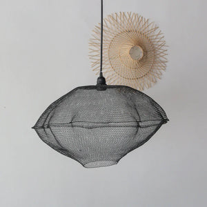 Modern black mesh pendant light with woven wall decor on white background