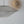 Modern wire mesh pendant light with organic, sculptural shape against white ceiling