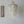 Elegant hanging seashell chandelier with hand-carved wooden wall decor on white wall