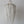 Handmade Balinese seashell chandelier with white beaded strands against plain wall