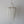Handmade Balinese white seashell chandelier with cascading beaded strands on a neutral background