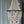 Handmade wooden bead chandelier with cascading strands in front of sheer curtains
