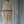 Handmade wooden bead chandelier pendant in front of sheer curtains.