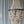 Handmade wooden beaded chandelier with natural finish in front of sheer curtains