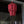 Handcrafted red beaded chandelier with layered design, hanging in a modern home entryway