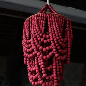 Handmade Balinese chandelier with cascading red wooden beads, artisanal home decor