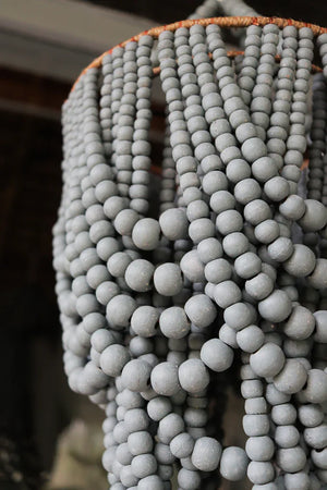 Close-up of handmade beaded chandelier with grey wooden beads, Balinese home decor