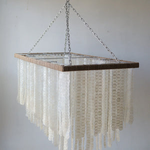 Handmade rectangle Capiz shell chandelier with unique seashell motifs, suspended by a chain.