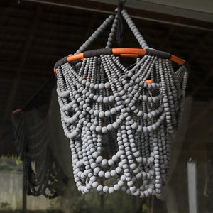 Handmade gray beaded chandelier with woven details, hanging indoors for home decor