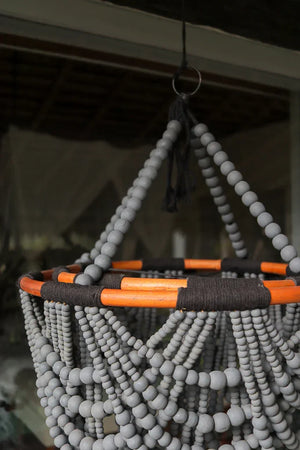 Handmade beaded hanging decor with grey wooden beads and orange accents, Balinese style