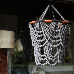 Handmade Balinese beaded chandelier with grey wooden beads, boho decor style.