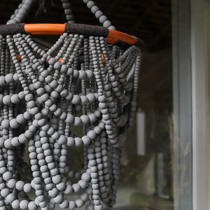 Handmade Balinese beaded chandelier with gray beads and wood accents for home decor