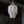 Handmade Balinese white seashell chandelier hanging in front of a window