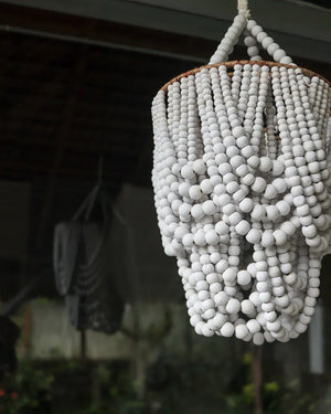 Handmade white beaded chandelier with boho style, hanging indoors