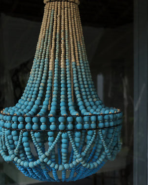 Handmade blue beaded chandelier with ornate draping, Balinese-inspired decor piece