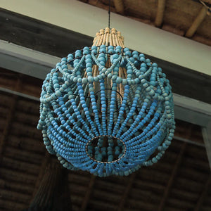 Handmade blue beaded chandelier hanging from ceiling, Balinese decor style