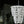Handcrafted white beaded chandelier with layered strands, hanging in a modern decor setting
