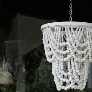 Handcrafted white beaded chandelier with layered strands, hanging in a modern decor setting
