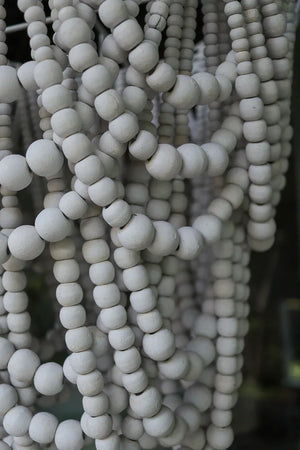 Close-up of natural wooden bead strands used in handmade Balinese home decor.