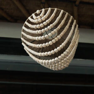 Handmade Balinese seashell chandelier with natural beads and rope, hanging indoors