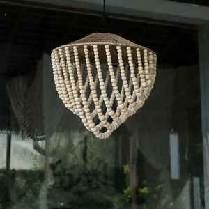 Handmade Balinese wood bead chandelier with natural fiber top, hanging indoors