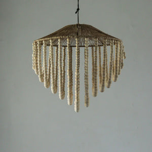 Handmade Balinese chandelier with wooden beads and woven rattan frame, hanging indoors